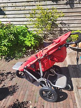 I have a wooden baby crib with a mattress and a red Easy Walker stroller, buggy and separate carrycot.