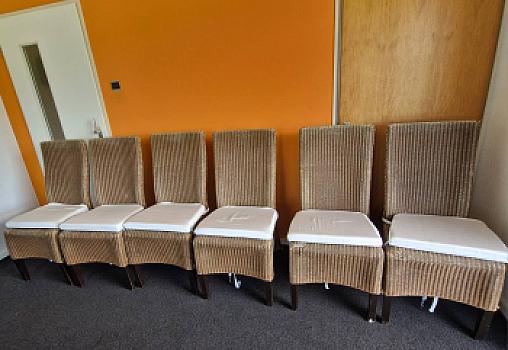 6 wicker dining chairs with white cushions